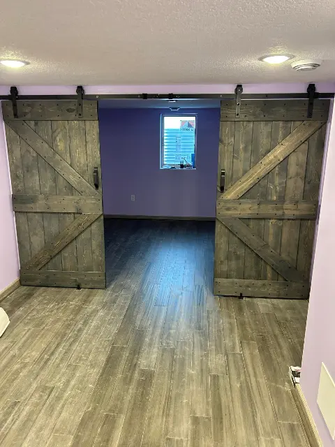 Rustic sliding barn doors in remodeled Twin Cities basement