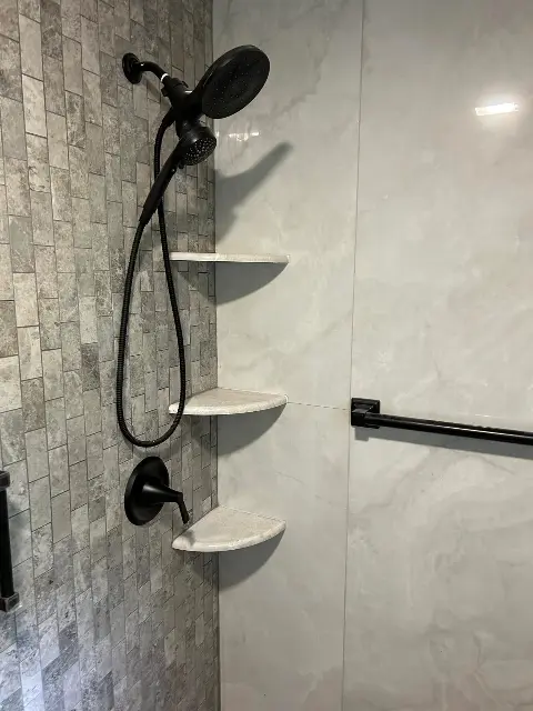 Stylish shower with marble shelves and black fixtures